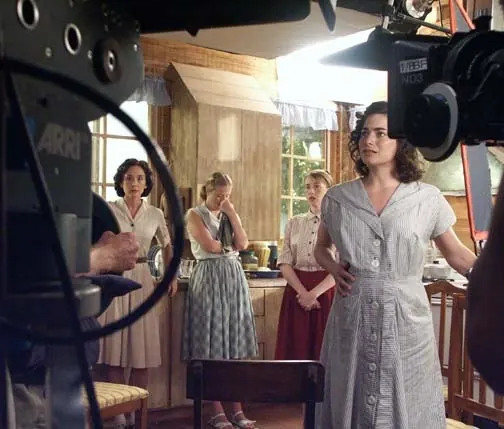 Cinematographer filming an actress in costume on the End of the Spear set