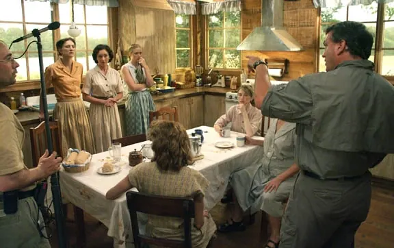 Director briefing the cast in the kitchen set of End of the Spear