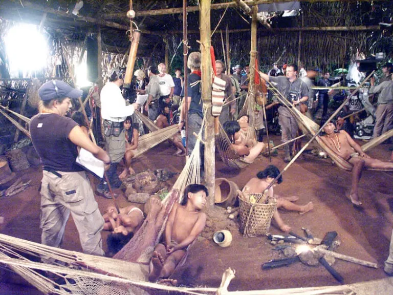 Film crew and Waodani actors on the set of End of the Spear inside a recreated jungle hut