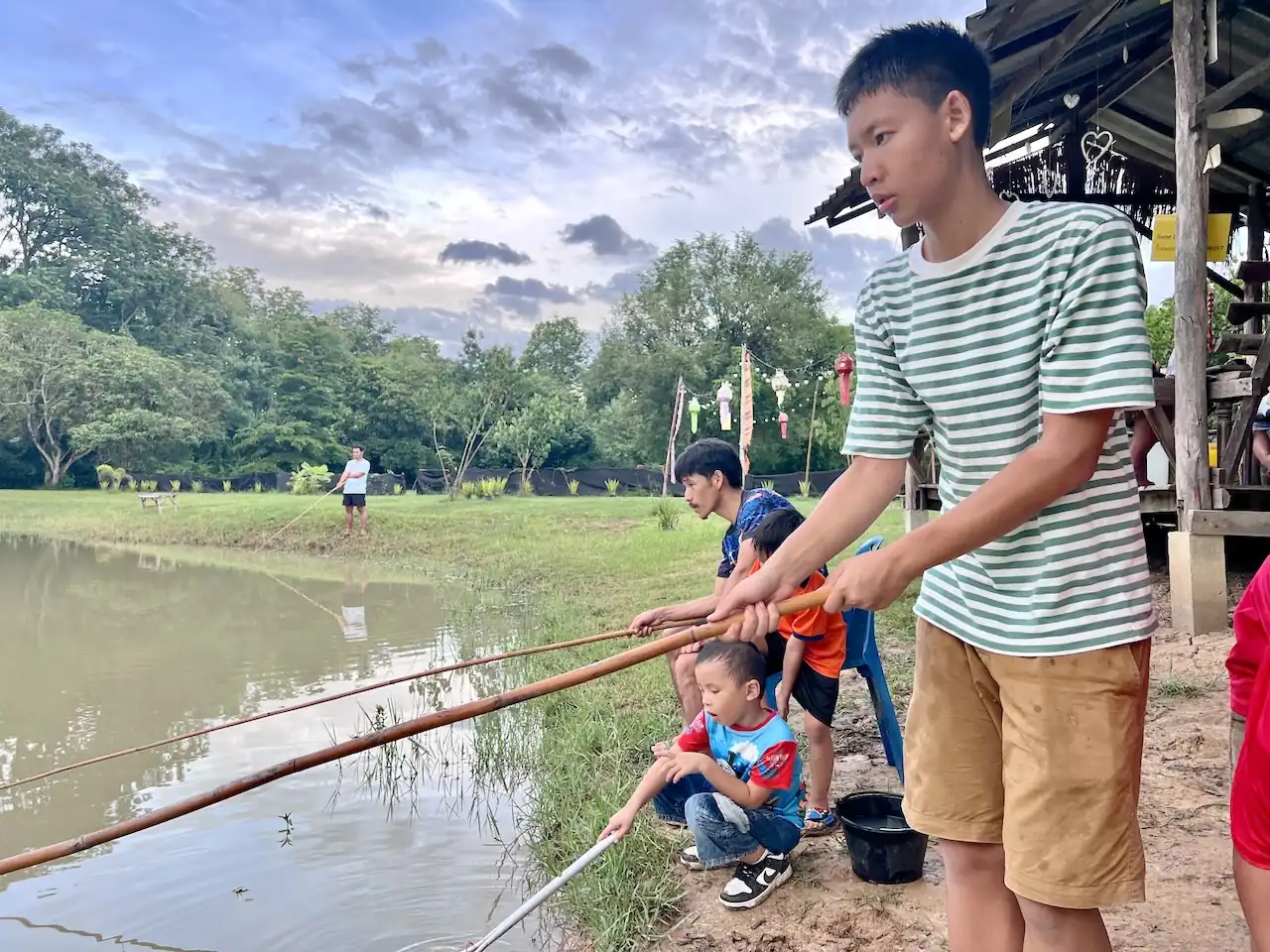 Boy fishing at the Camp 99 pond in the evening light