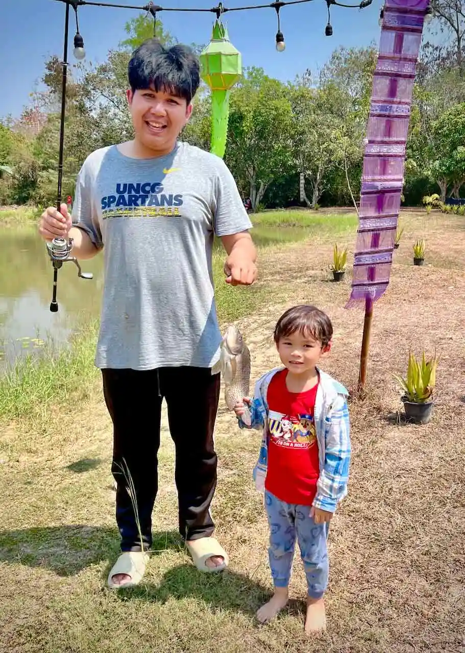 Grandparent fishing with a young boy at Camp 99