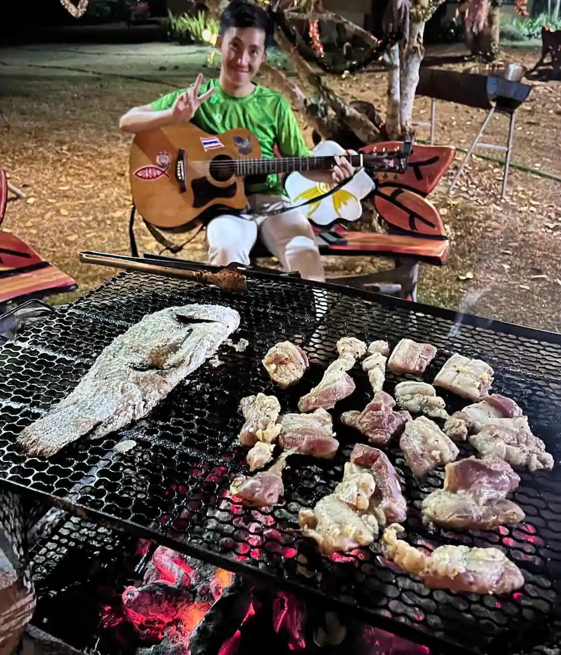 Fish and meat on the BBQ grill with a guitarist at Camp 99