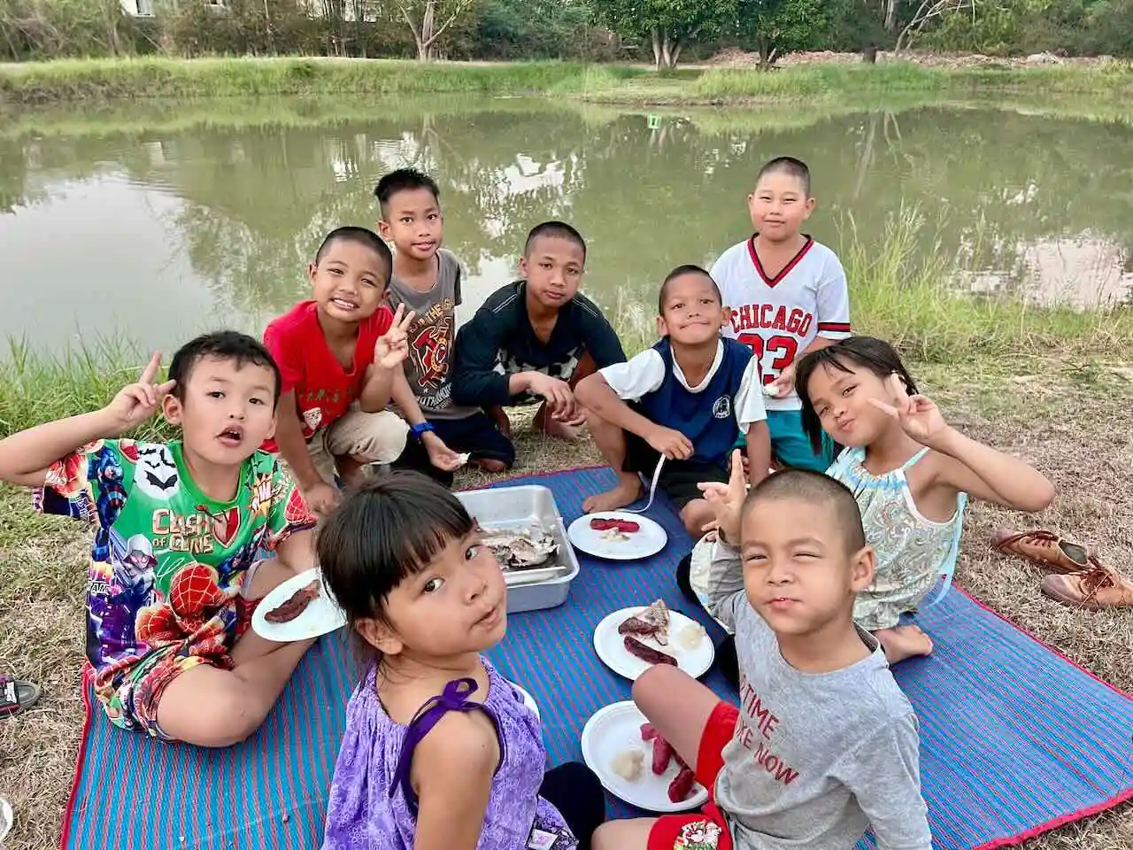 Kids enjoying a picnic beside the Camp 99 pond
